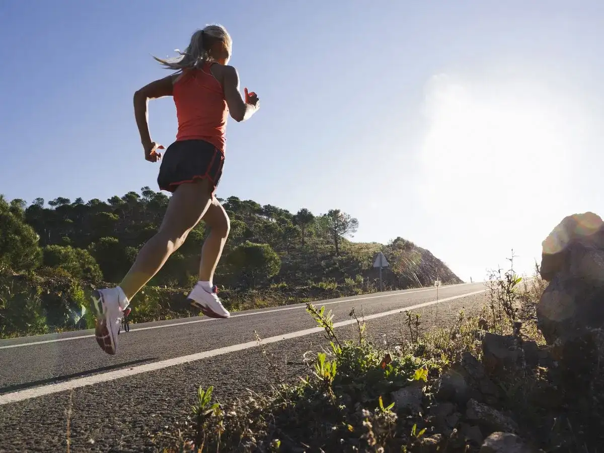 Runner running on the road hill