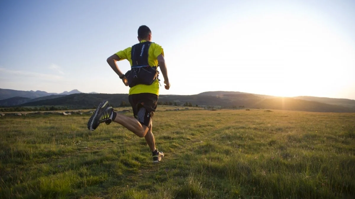 Man is running with a weighted vest
