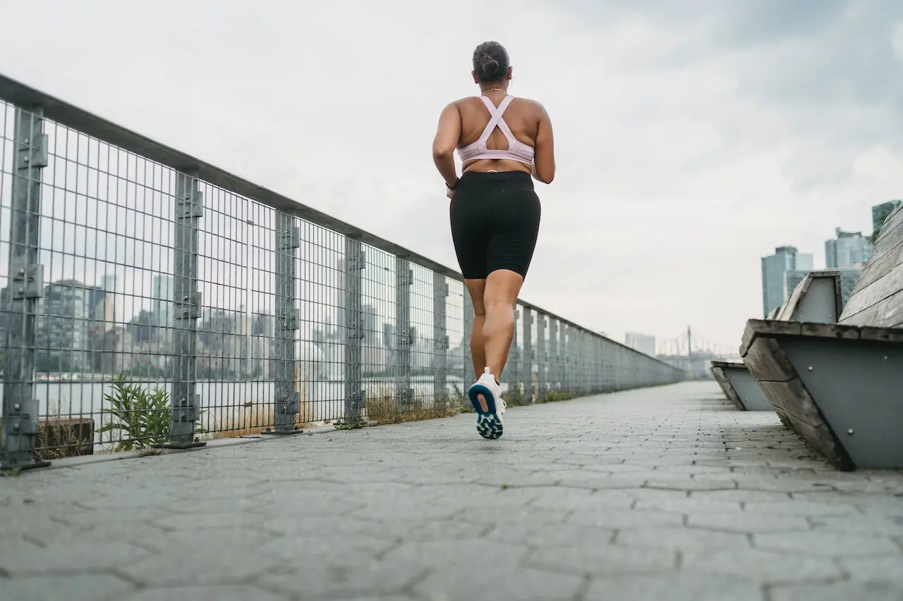 Woman running on sidewalk