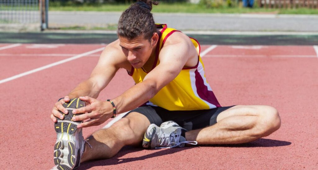 Runner doing leg stretching after running