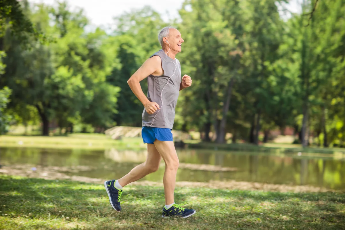 Older man runner running in park