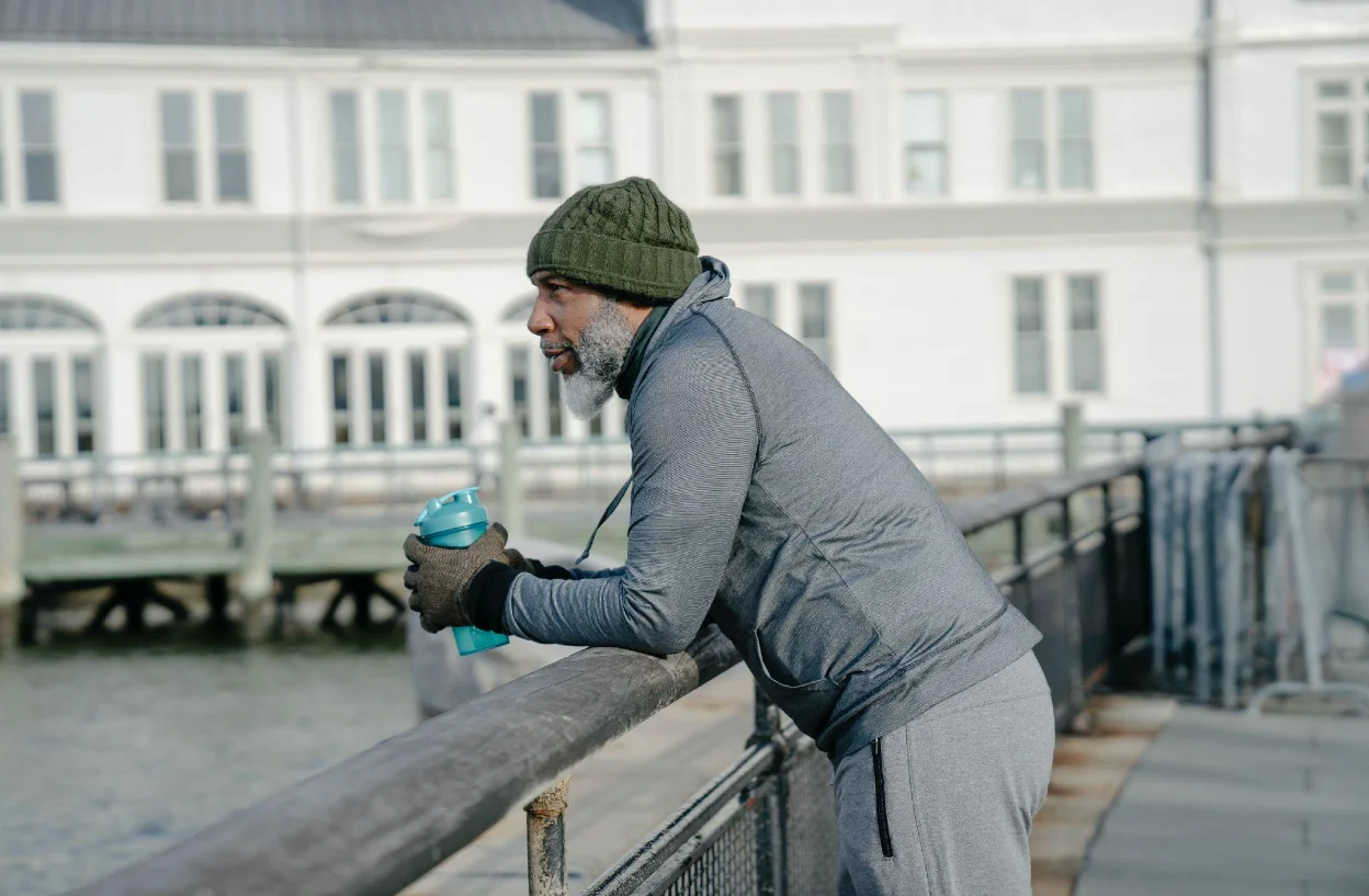 Man runner with water to stay hydrated during the race