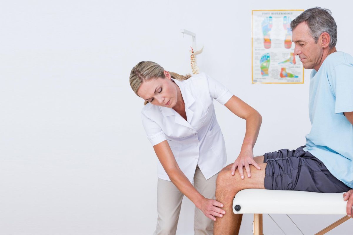 Doctor examining a runner's knee joint