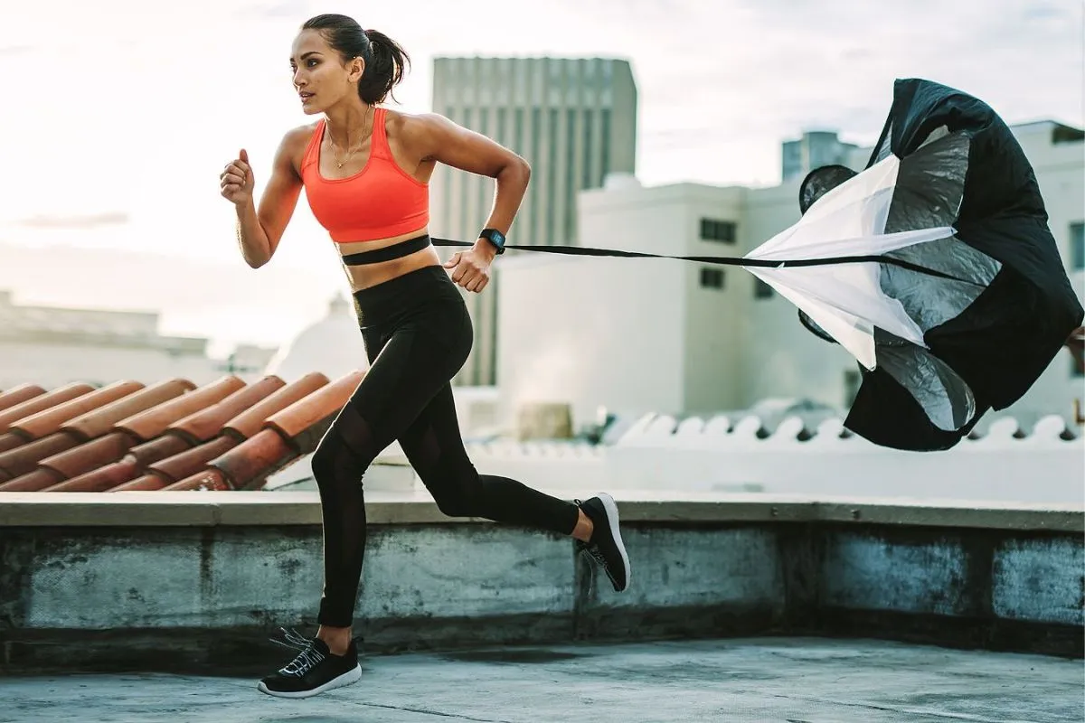 Woman running with parachute