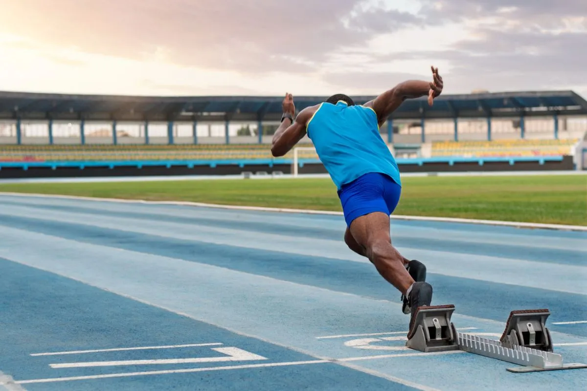 Man start sprinting around a stadium