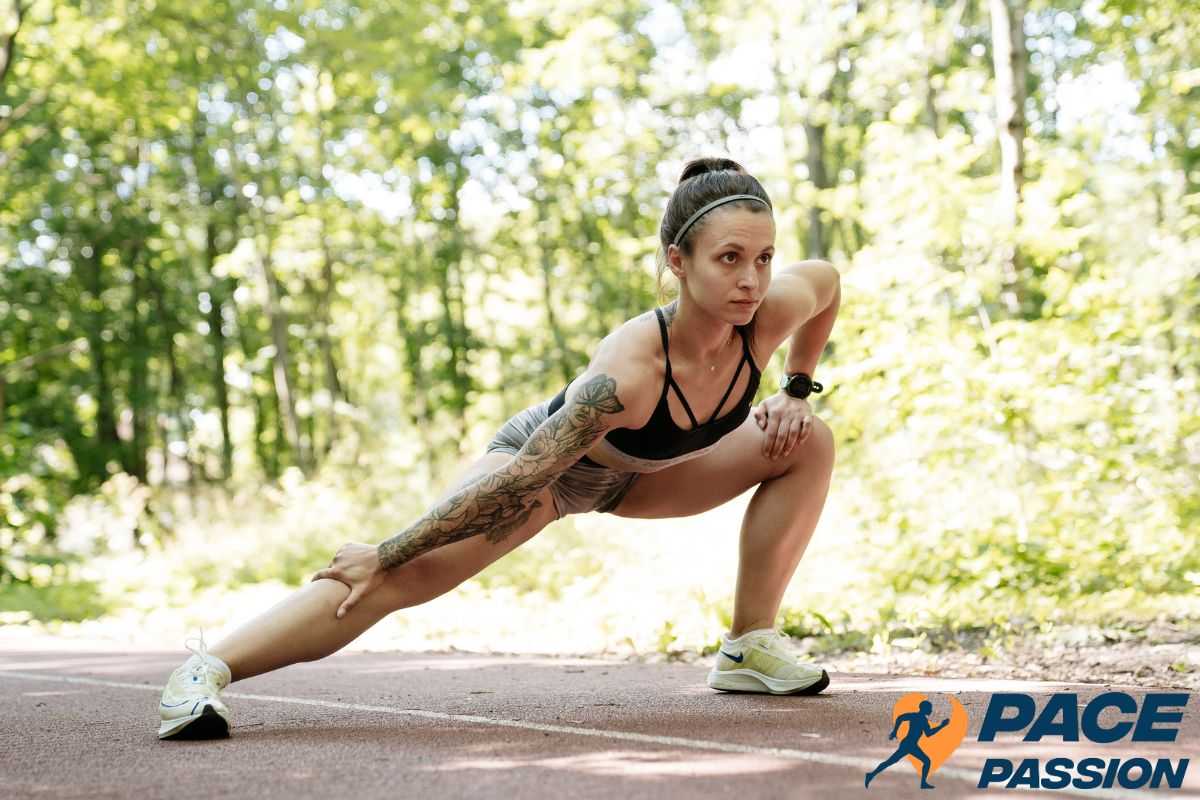 A female runner warms up with stretches before her run to prevent cramps while running