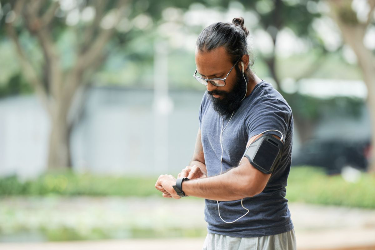 Man is monitoring and tracking his progress by counting the number of steps he covered throughout the day