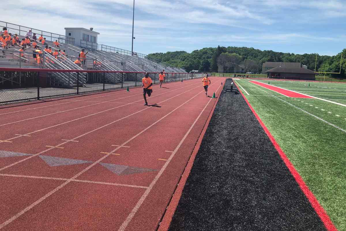 Athletes jogging on the stadium surface
