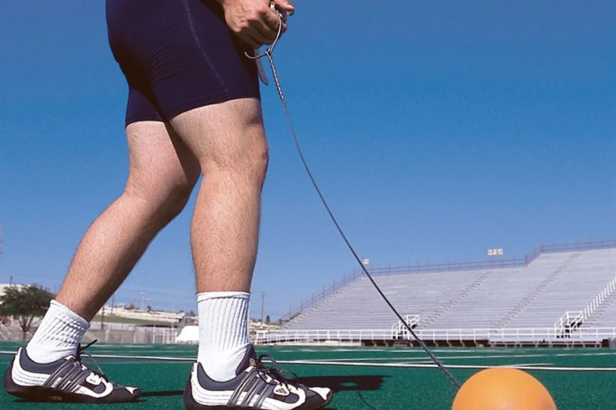 Hammer throw competitor ready to throwing a ball attached to a wire