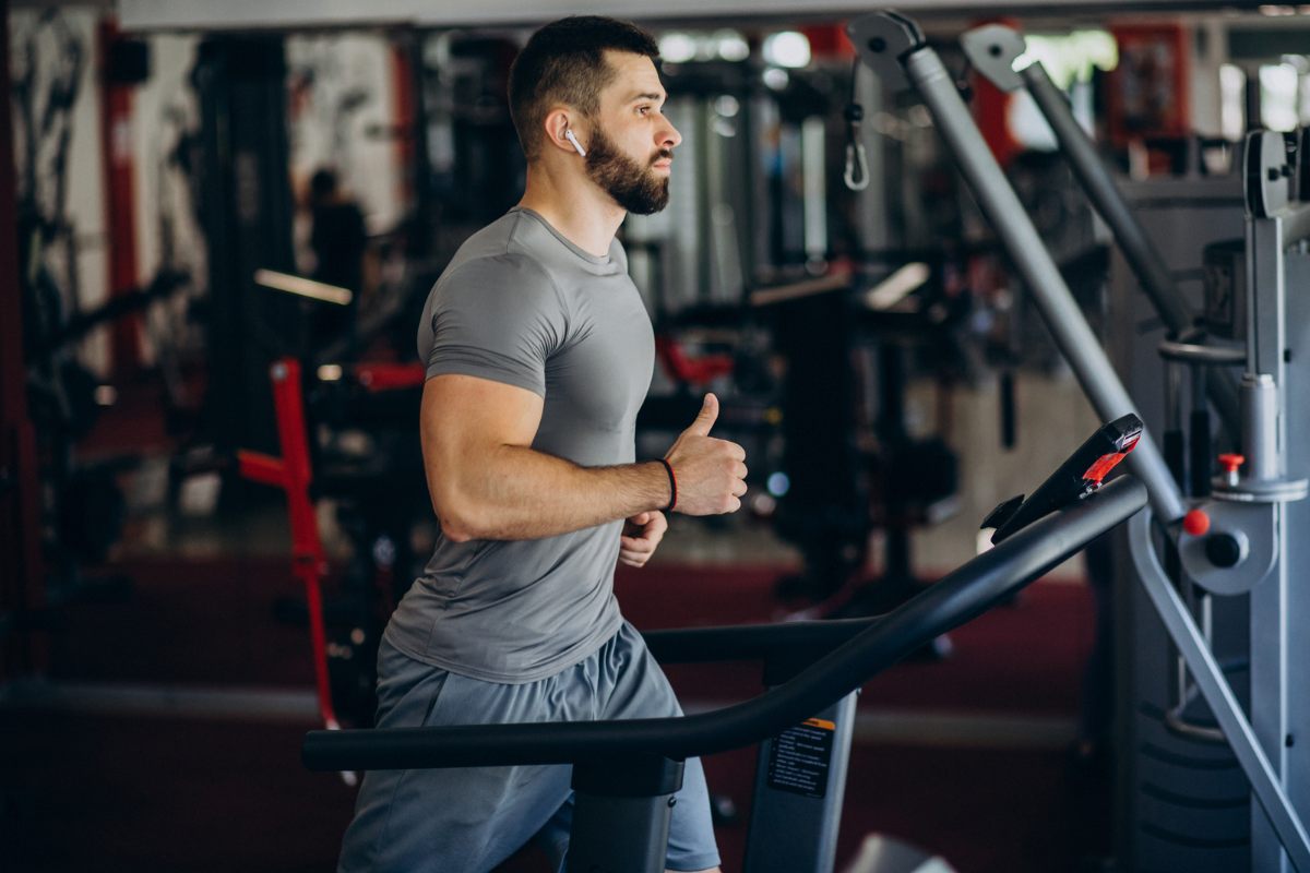 A man engaging in high-intensity exercises on a manual treadmill