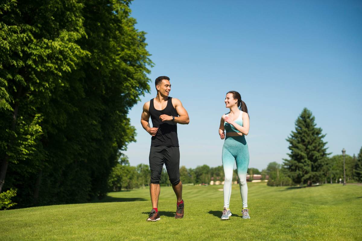 A man and a woman walking in the park