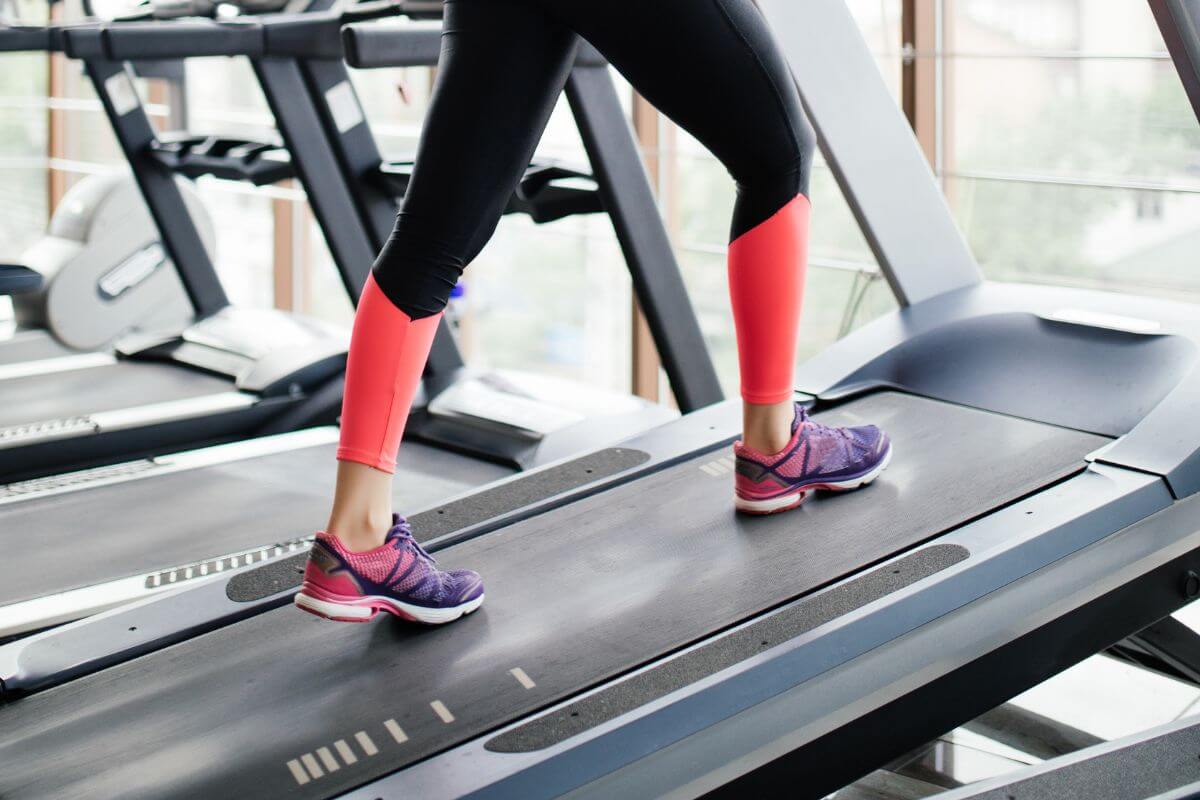 Woman walking on an incline treadmill
